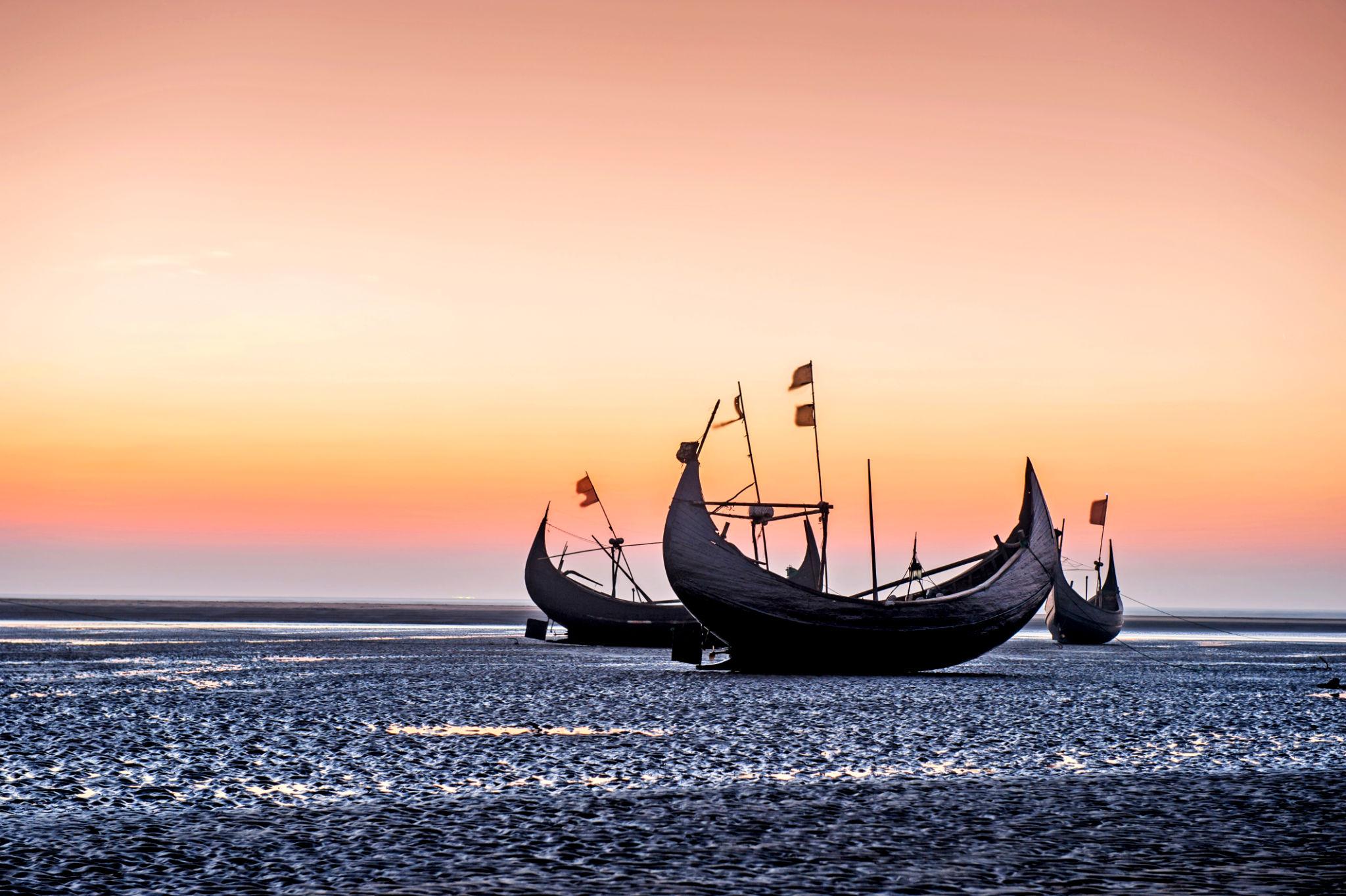 Moon boats at sunset over the Bay of Bengal
