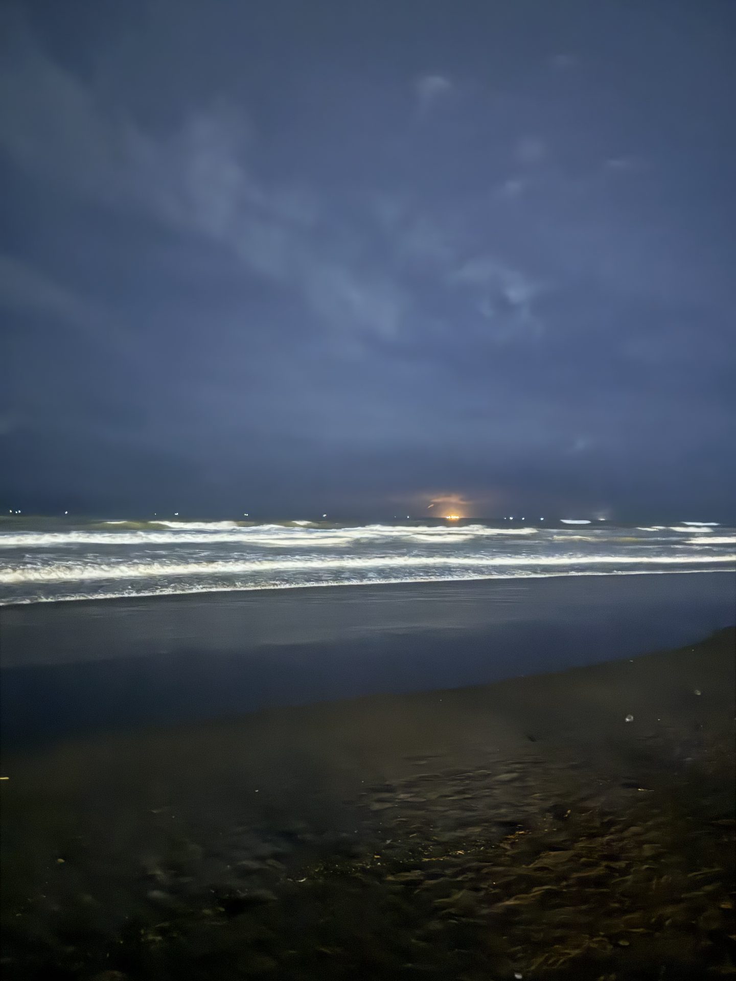 Surf breaking on the Cox's Bazar shoreline after dark