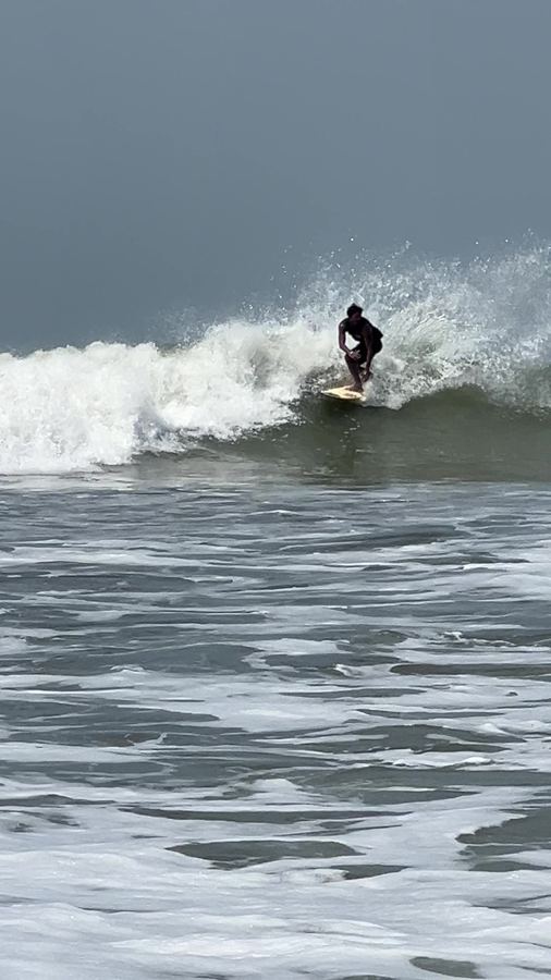 A local surfer turning on a green wave