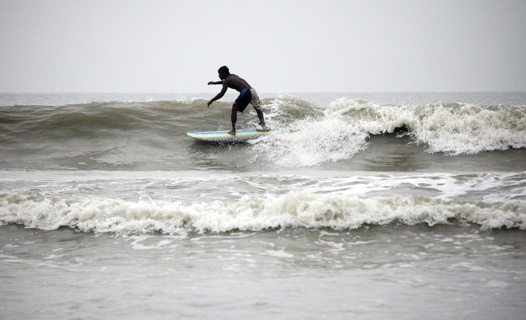 Surfer riding a wave at Cox's Bazar